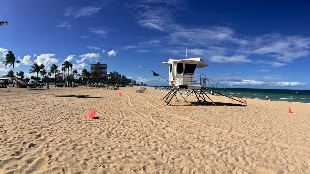 white and brown lifeguard house on beach during daytime