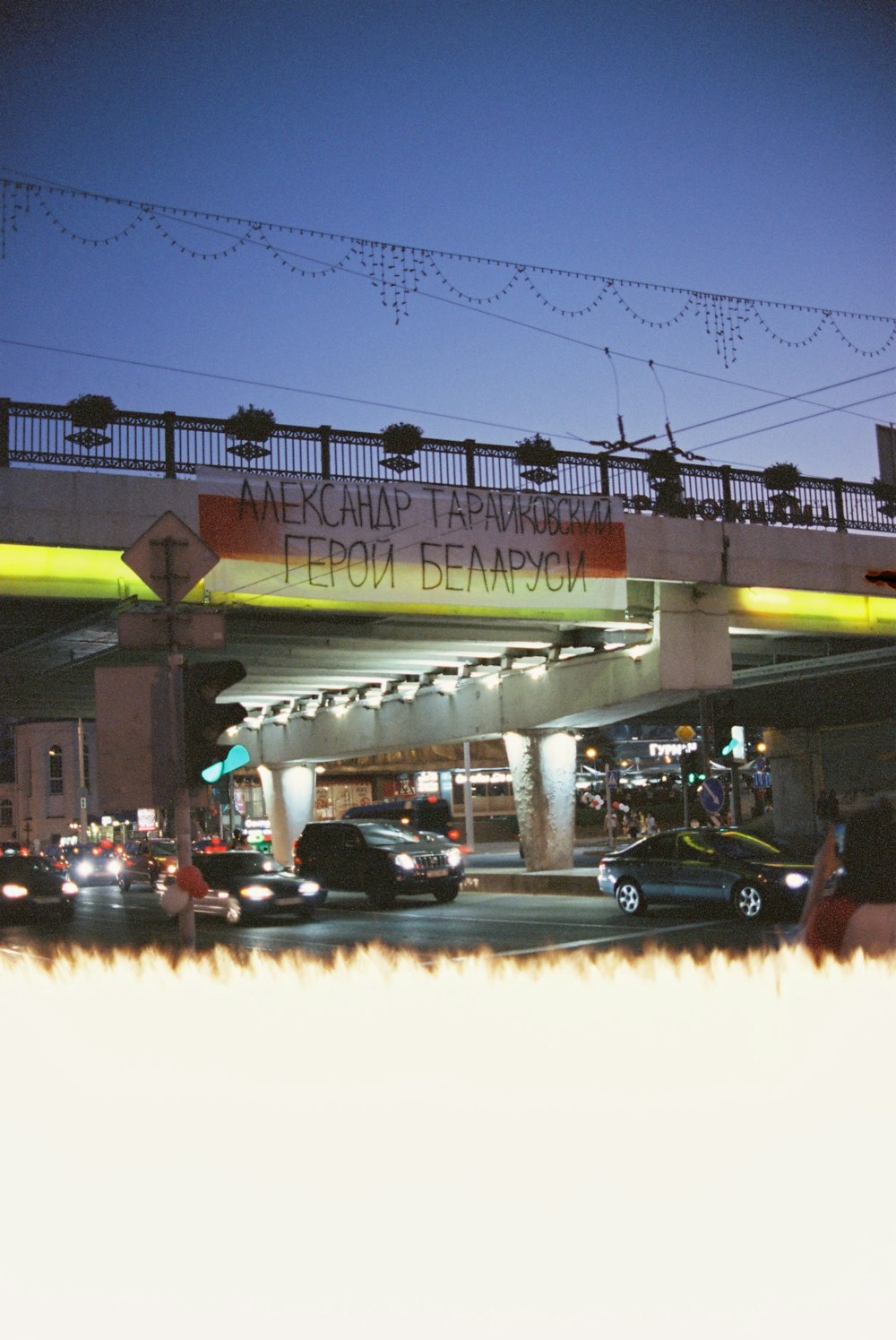 cars parked in front of yellow and green building during night time