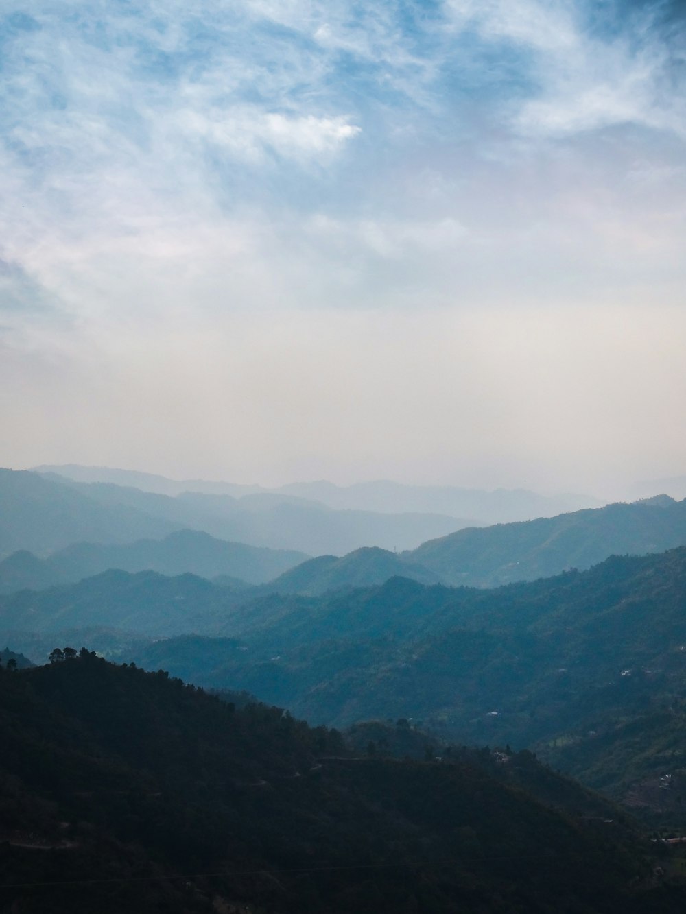 green mountains under white clouds during daytime