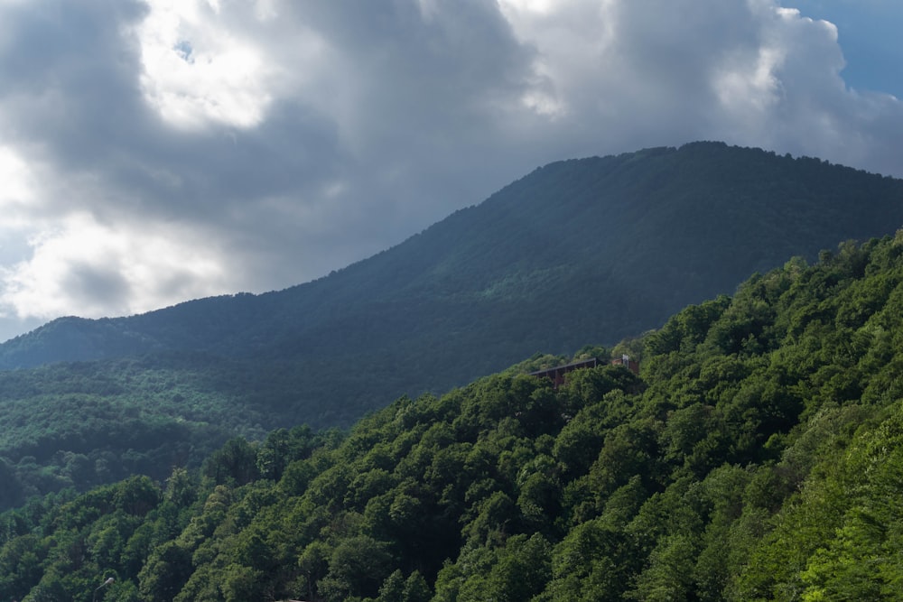 green mountain under white clouds during daytime