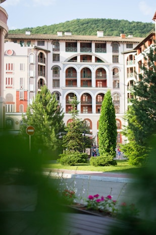 Charming exterior view of Acassuso Suites building surrounded by greenery