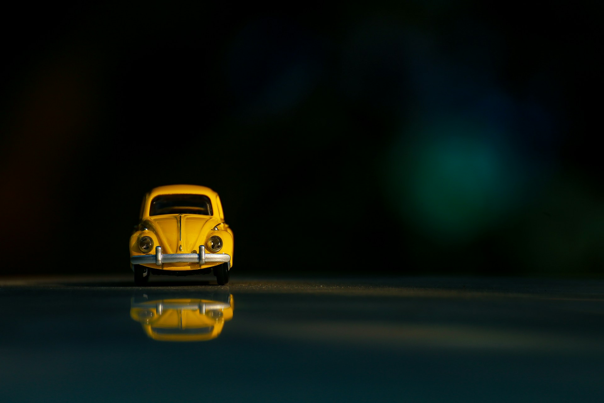 yellow car on black asphalt road