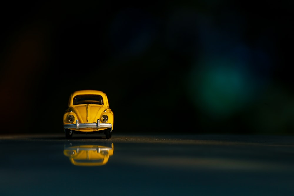 Auto gialla sulla strada asfaltata nera