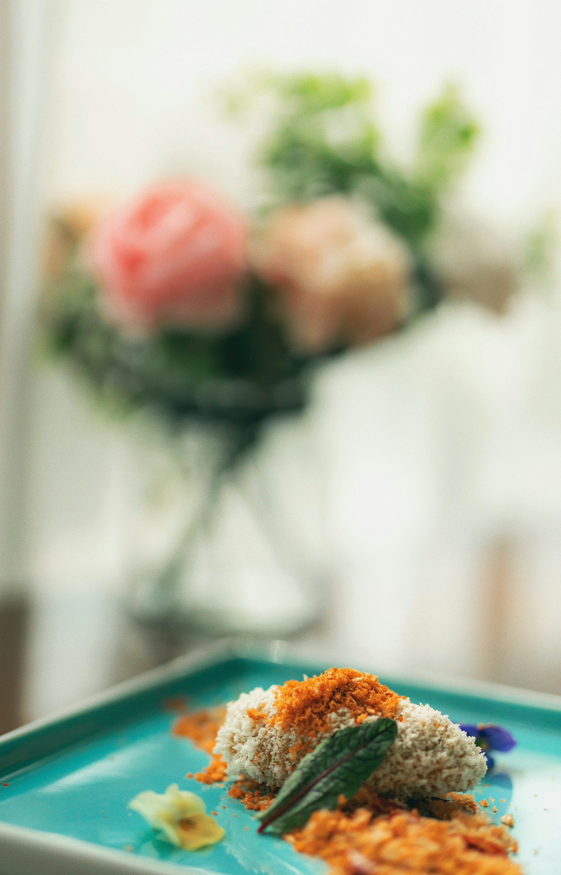 A close-up shot of a beautifully plated gourmet dish, highlighting vibrant colors and intricate textures under soft, cinematic lighting.