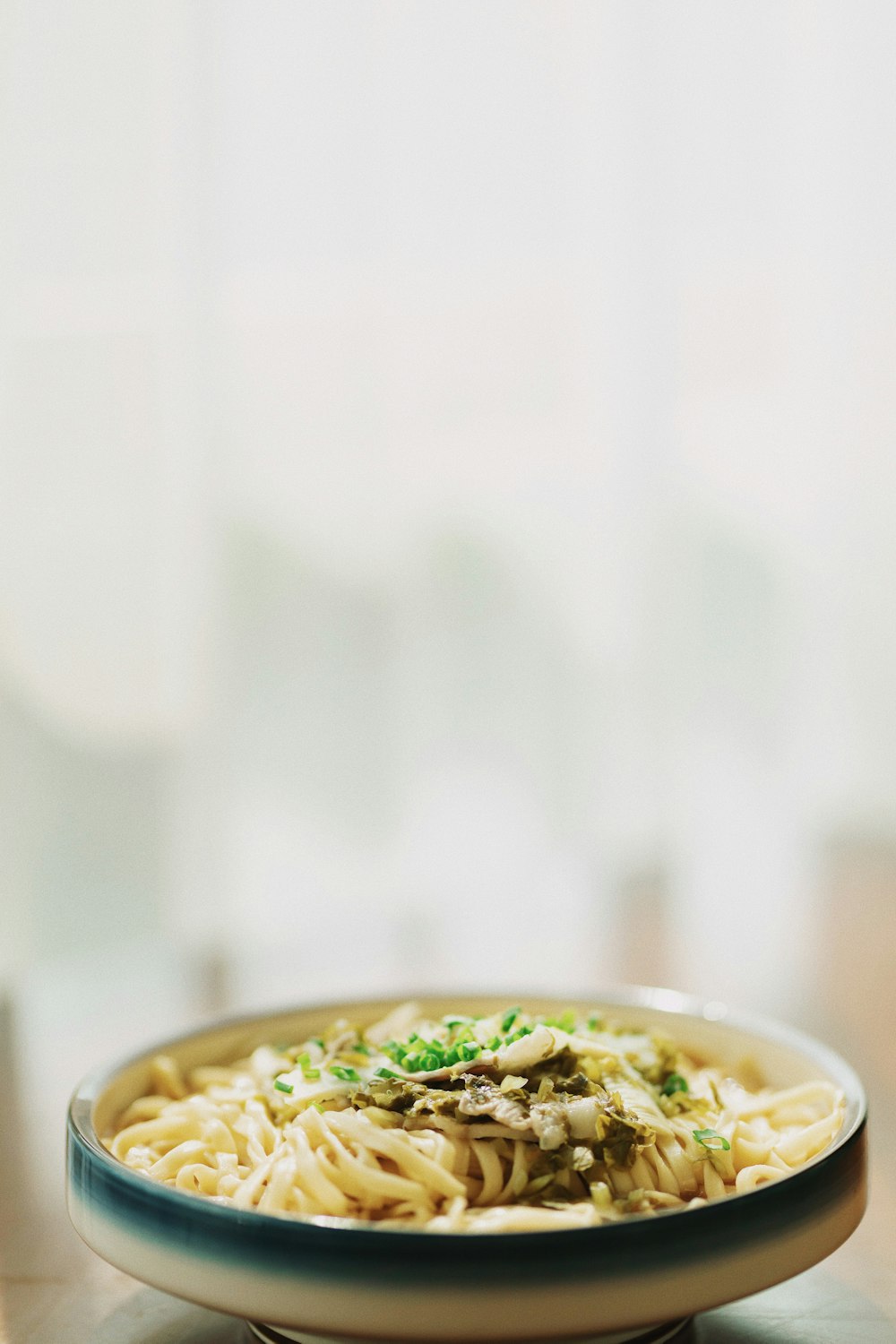 white ceramic bowl with green leaves