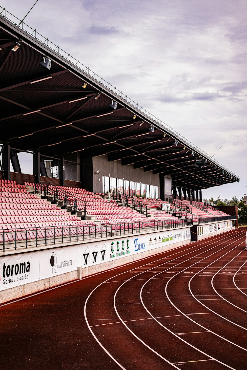 red and white stadium under white clouds during daytime