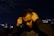 man in black hoodie holding his face
