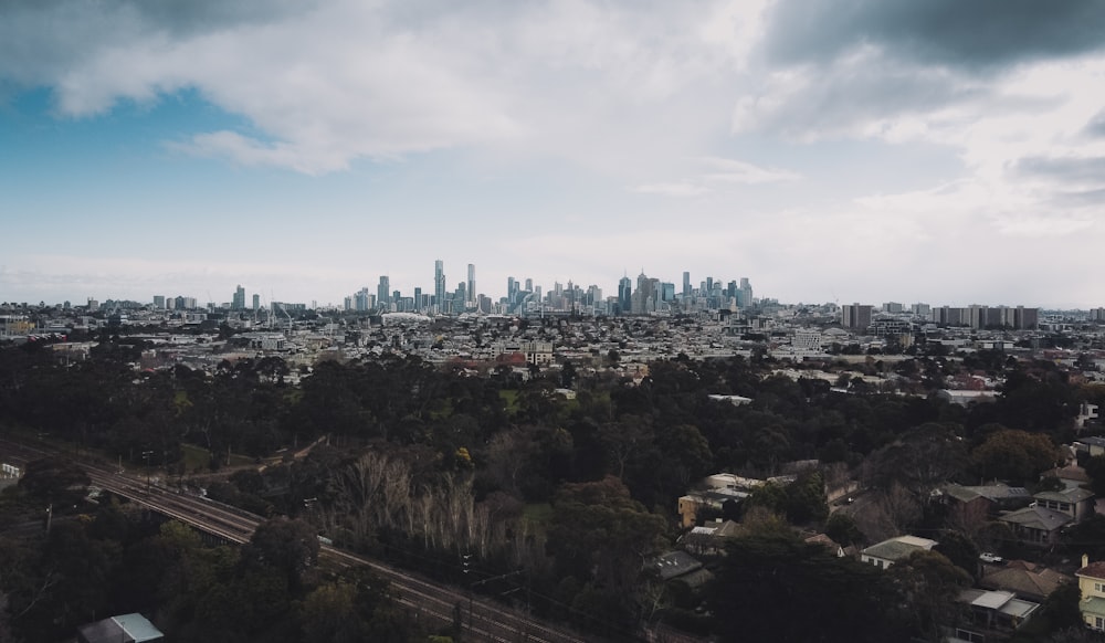 city skyline under white clouds during daytime