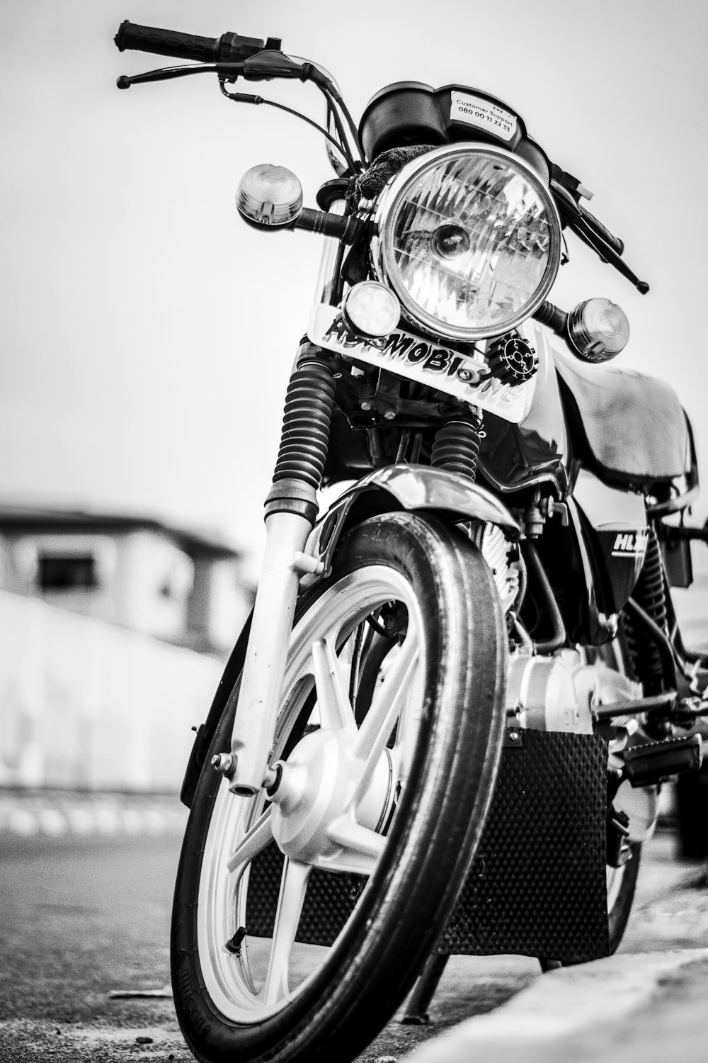 grayscale photo of motorcycle on road