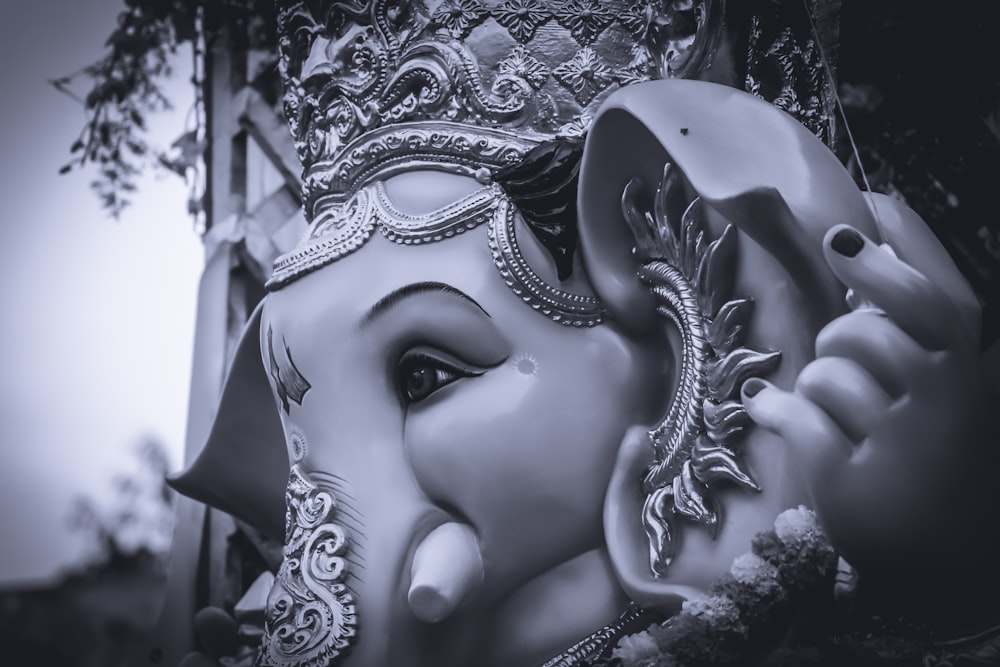 grayscale photo of womans face statue