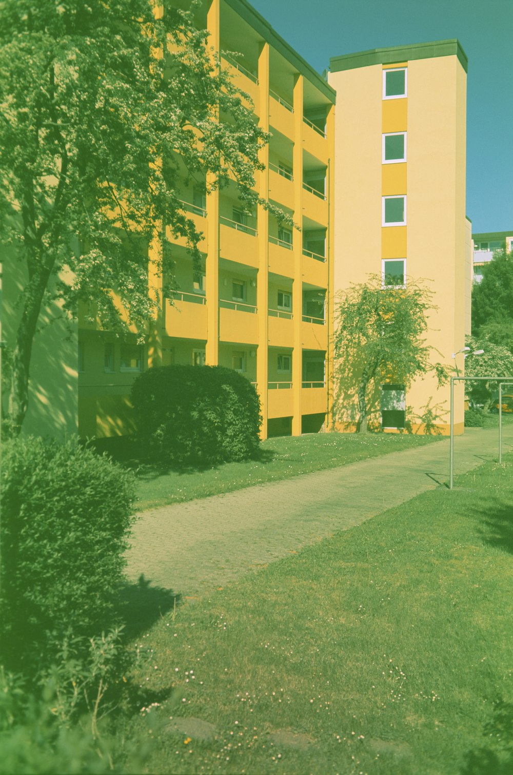 green grass field near white concrete building during daytime