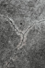 grey and brown concrete pavement cracked