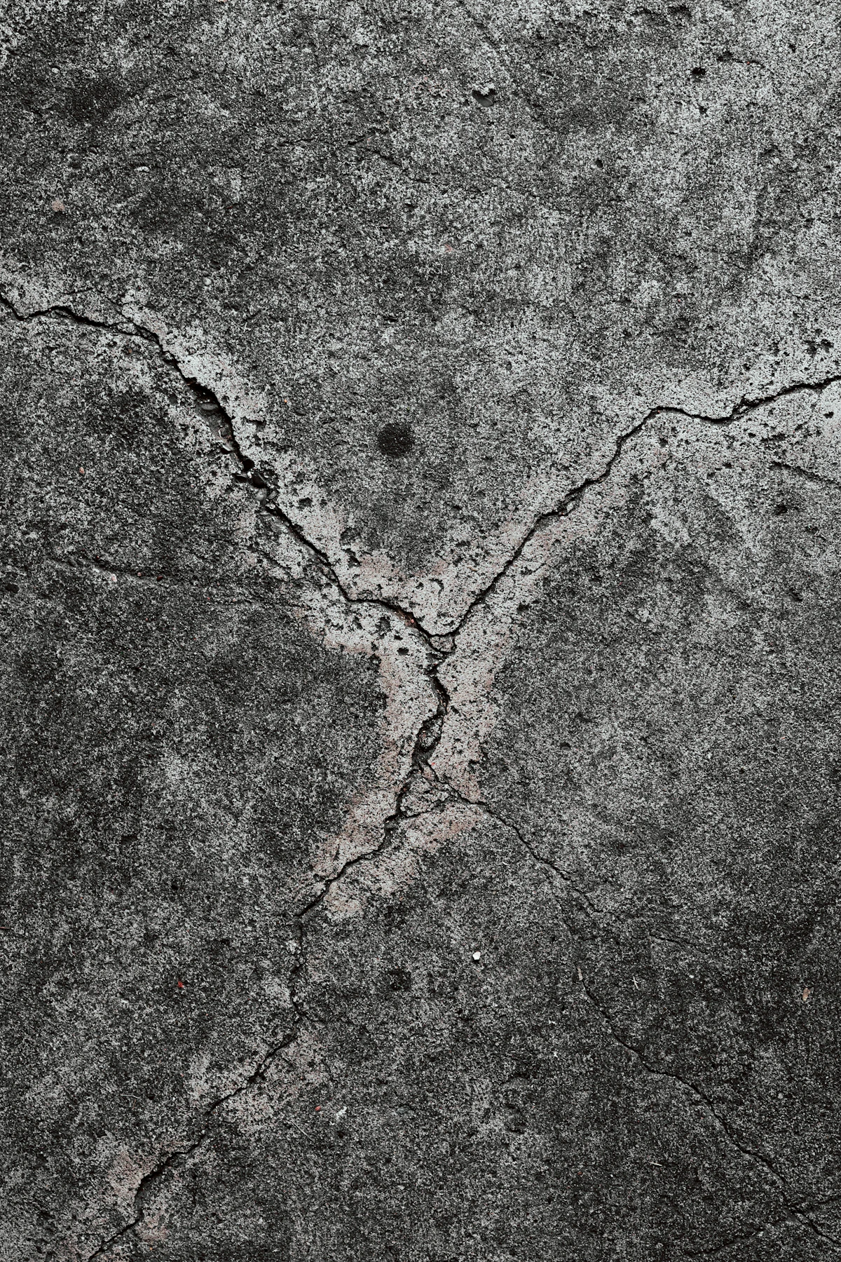 Crack running across a rendered concrete wall