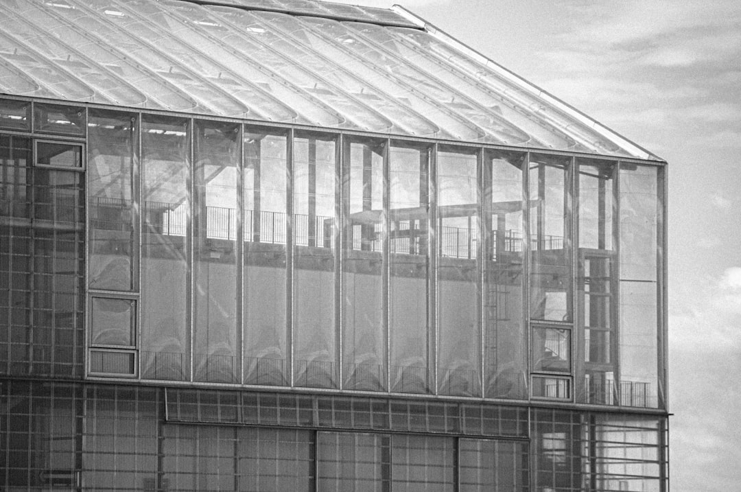 grayscale photo of glass building