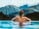 woman in blue swimming pool during daytime