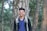 man in blue and white polo shirt standing beside tree