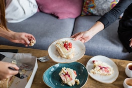 A happy family enjoying slices of cake together at a cozy home celebration.
