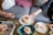 A joyful family sharing a beautifully decorated cake around a rustic wooden table.