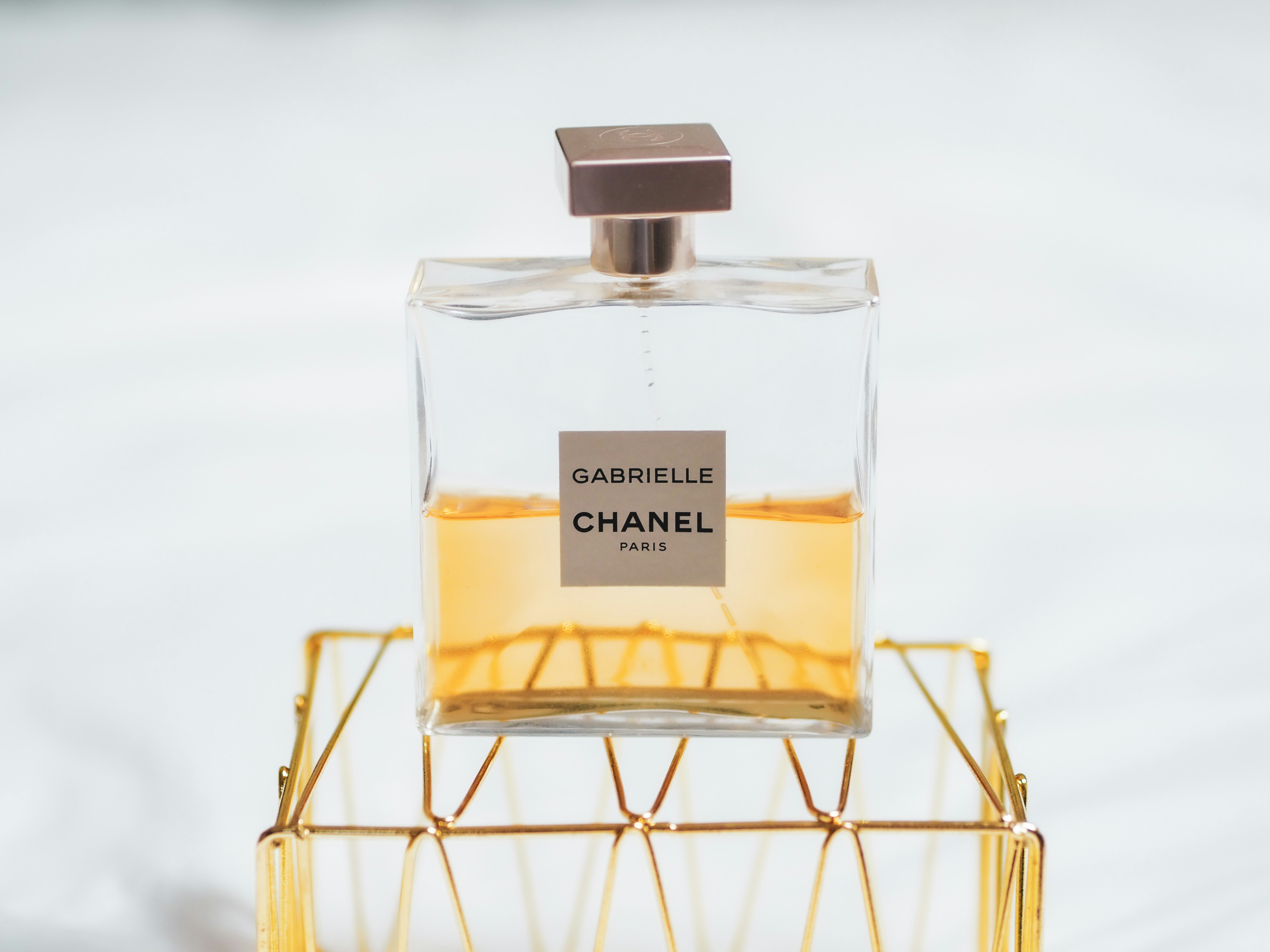 Editorial fragrance tray composition in warm neutral light