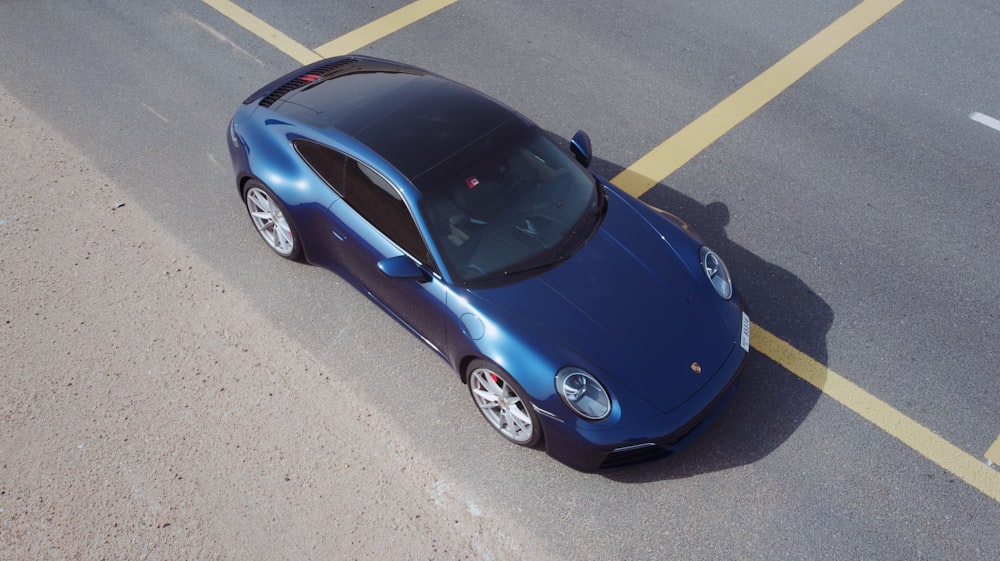 blue porsche 911 on road during daytime