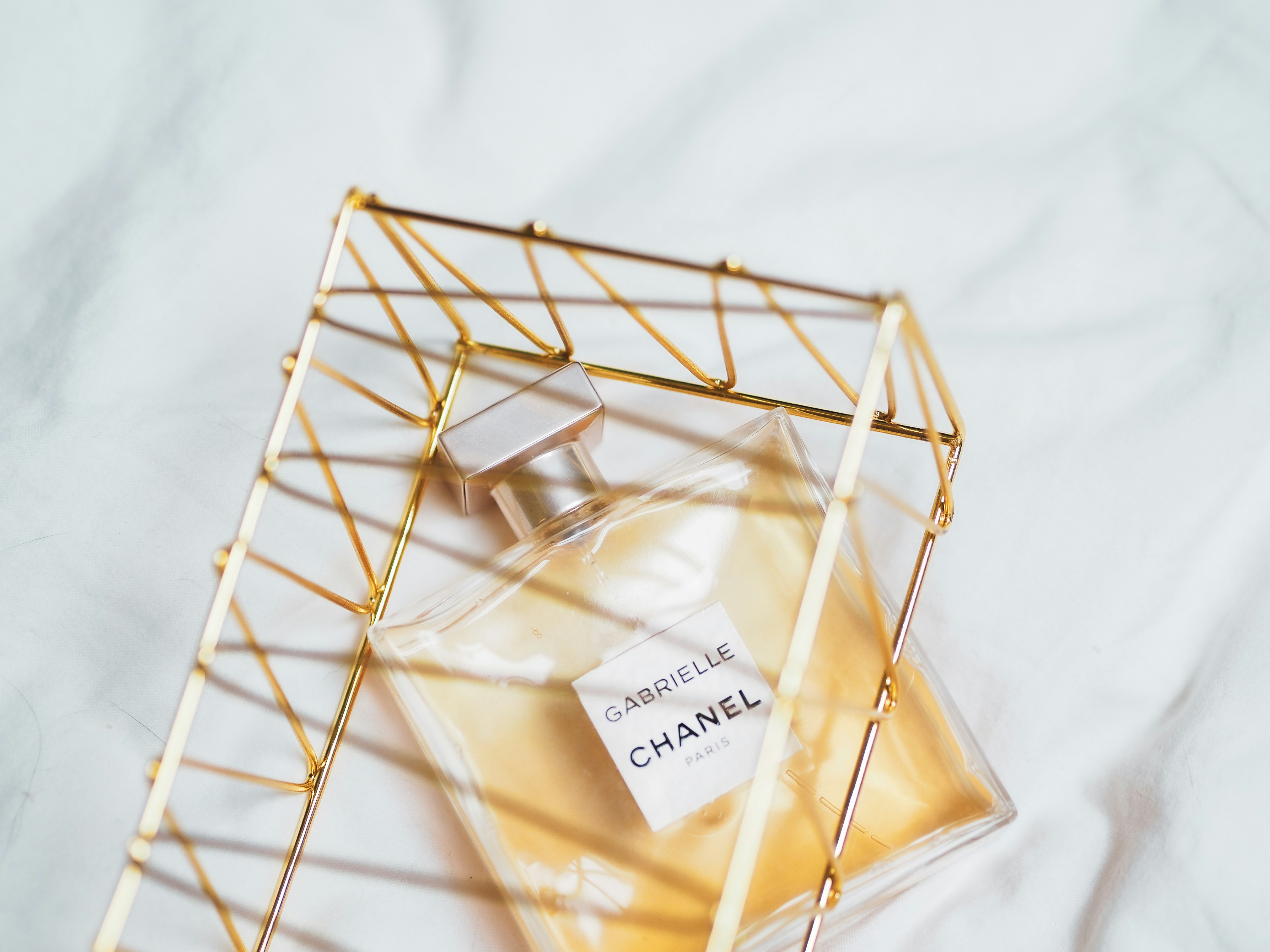 Editorial still life of perfume bottles and glass on a tray