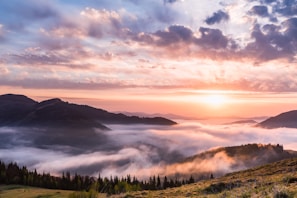 A breathtaking sunrise over the Dieng Plateau with mist rolling over the hills