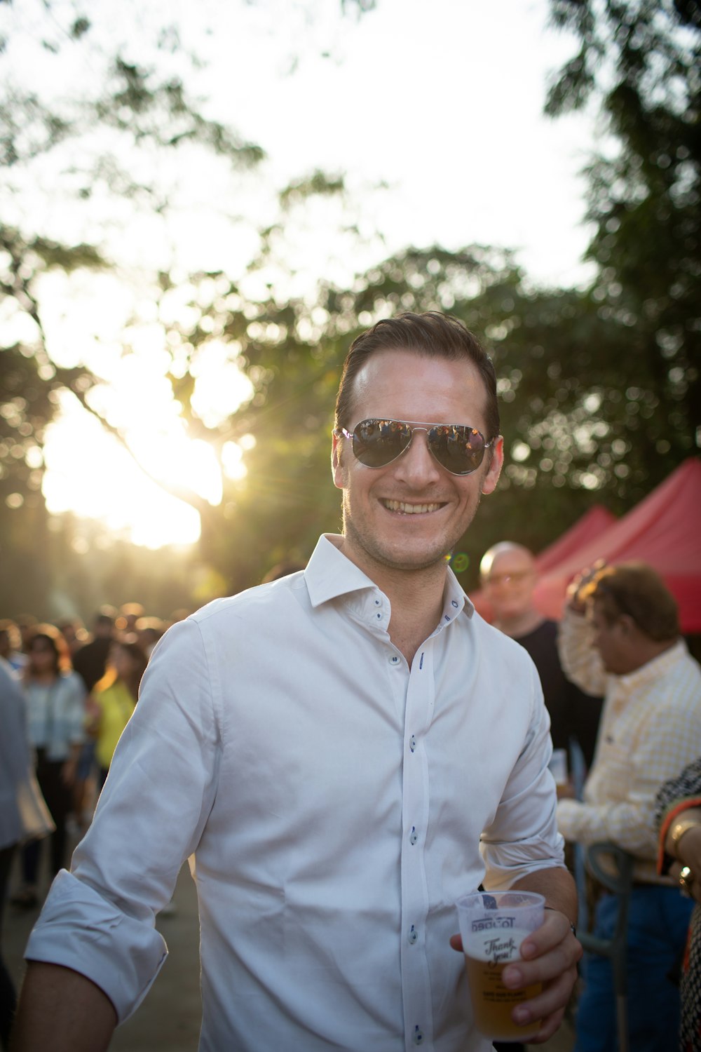 man in blue dress shirt wearing black sunglasses