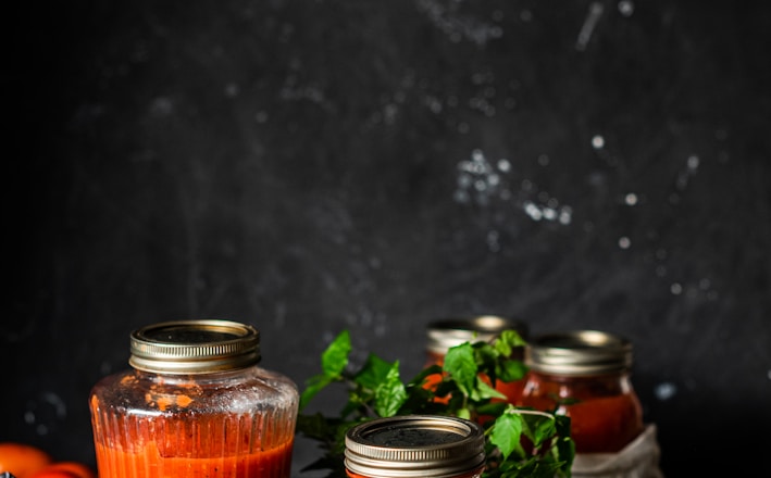 three clear glass jars on brown wooden table