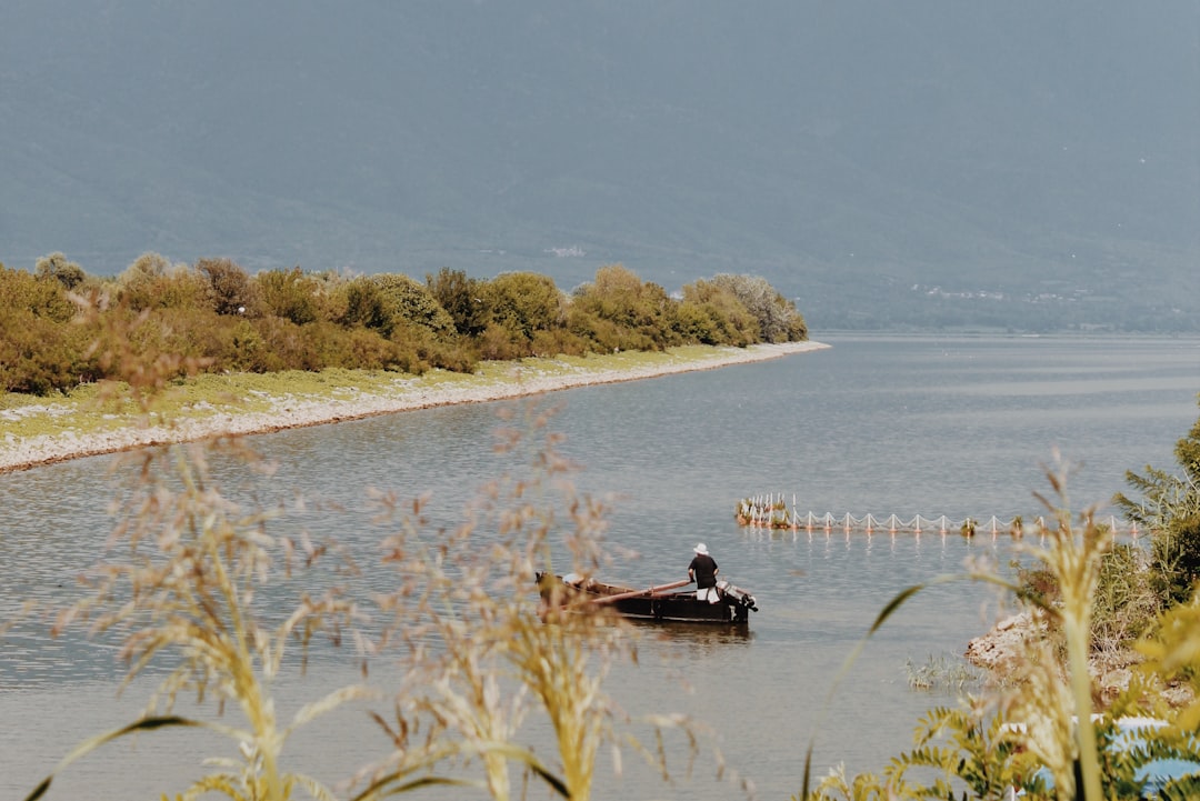 people riding boat on river during daytime