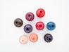 eight round pink blue and orange plastic cups