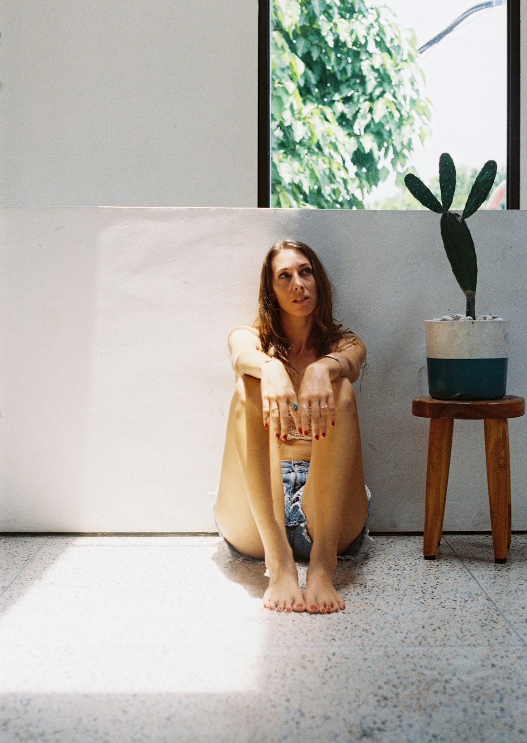 woman in yellow dress sitting on brown wooden seat