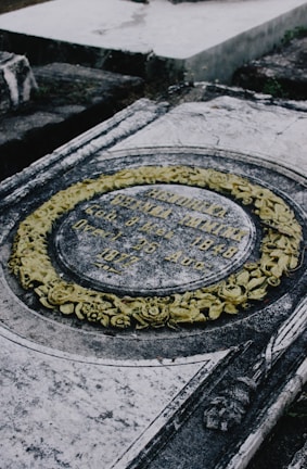 Close-up of a finely carved marble tombstone with elegant floral details