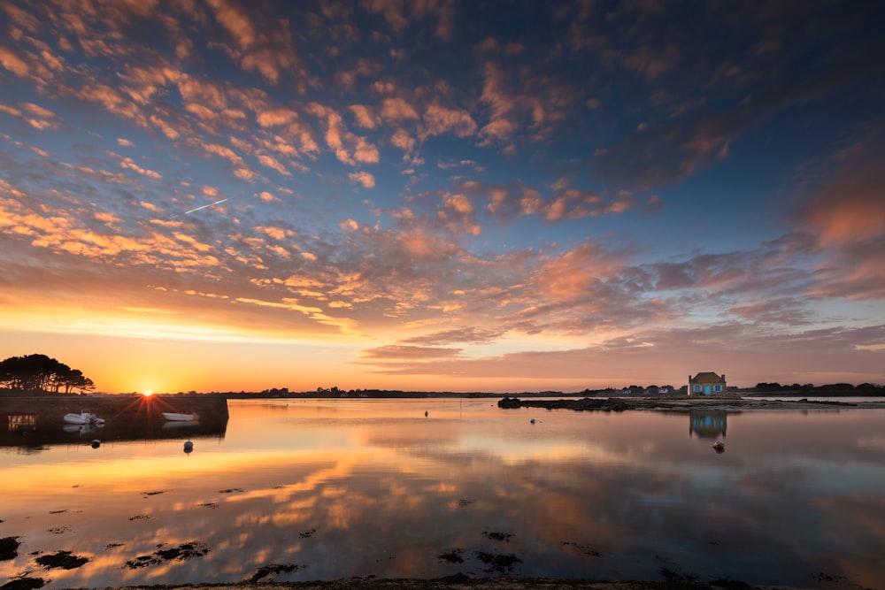 body of water under blue sky during sunset