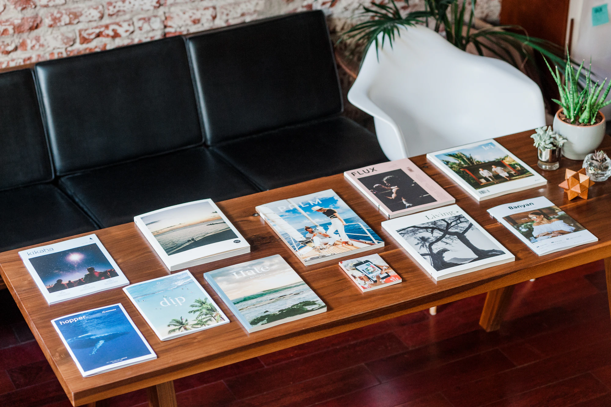 An editorial office desk with a notebook and a typewriter, photographed from above
