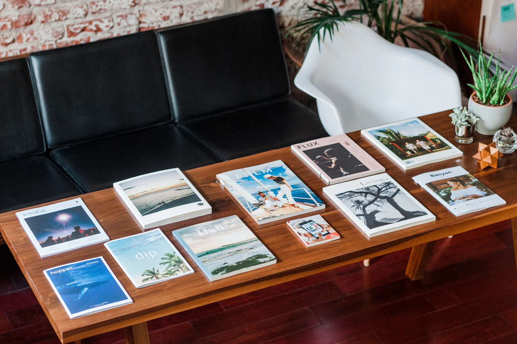 A considered selection of independent magazines arranged on a timber table