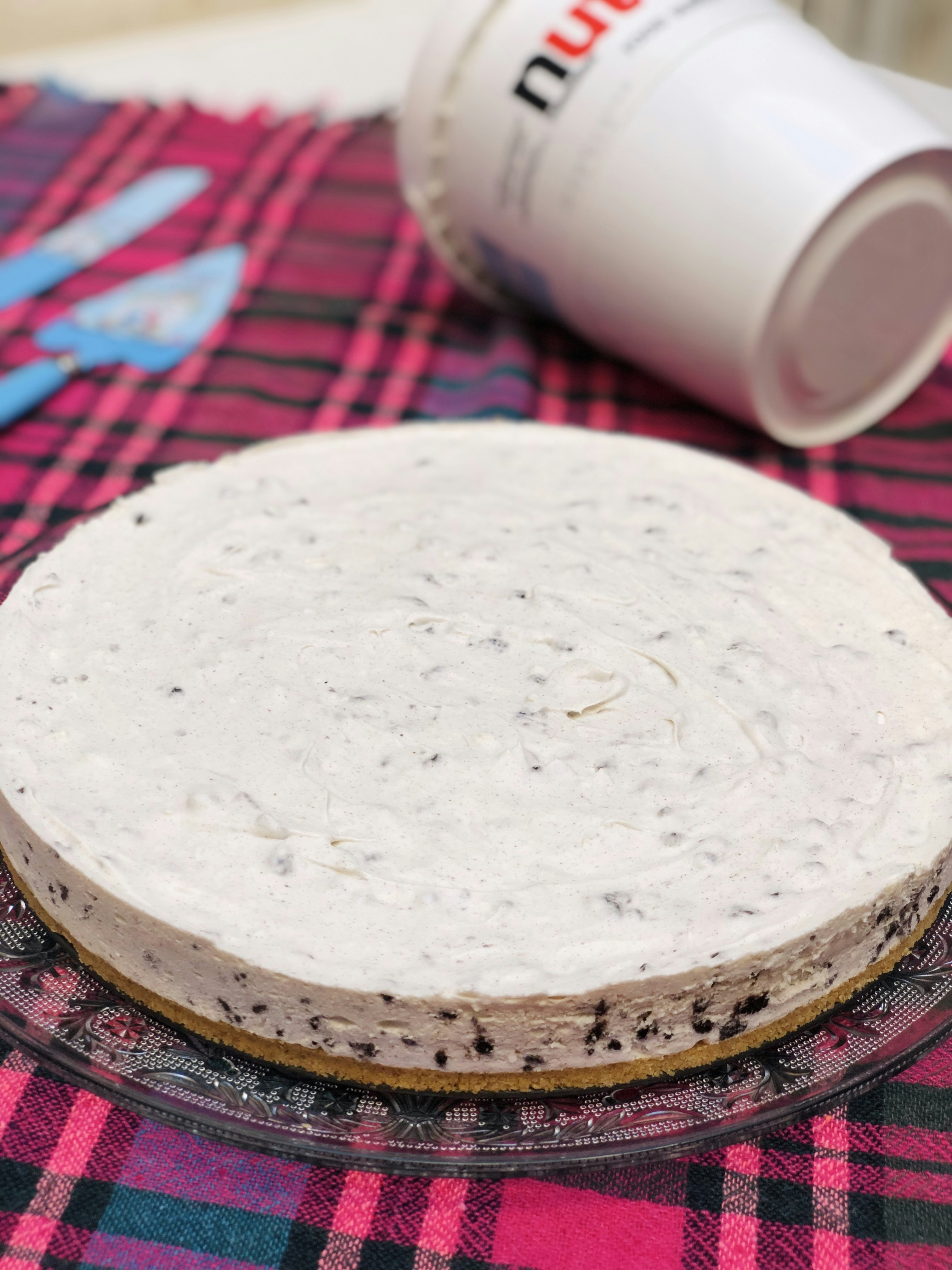 white round plate on red and white plaid textile