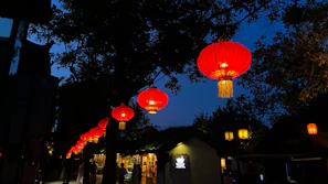 Evening view of the village with glowing lanterns hanging from trees