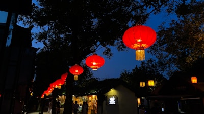 Evening scene with lanterns lighting up a peaceful outdoor fundraiser gathering.