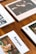Several lifestyle magazines are arranged on a wooden table. The publications have vibrant covers, including one with the title 'Banyan' and an image of a woman wearing sunglasses and stylish earrings. The photographed magazines are placed in a neat, overlapping pattern.