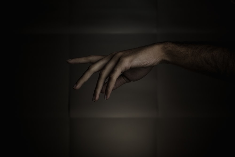 persons left hand on black surface