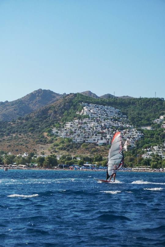 white sail boat on sea near mountain during daytime in Bodrum Turkey