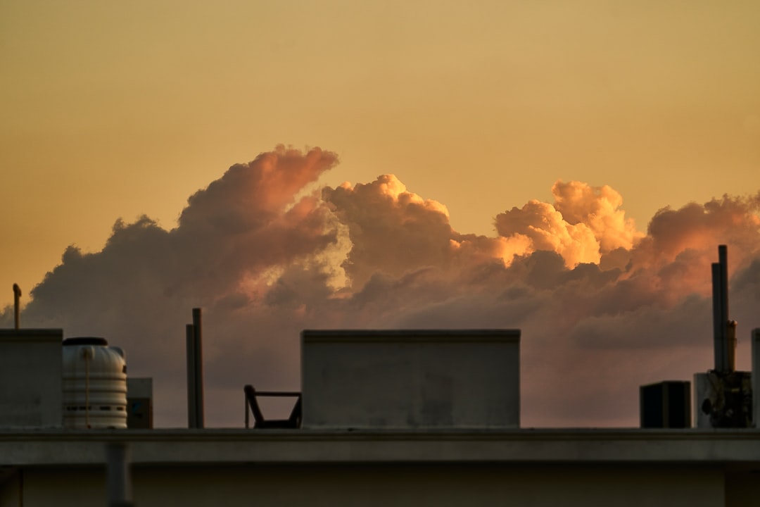 silhouette of building under cloudy sky during daytime