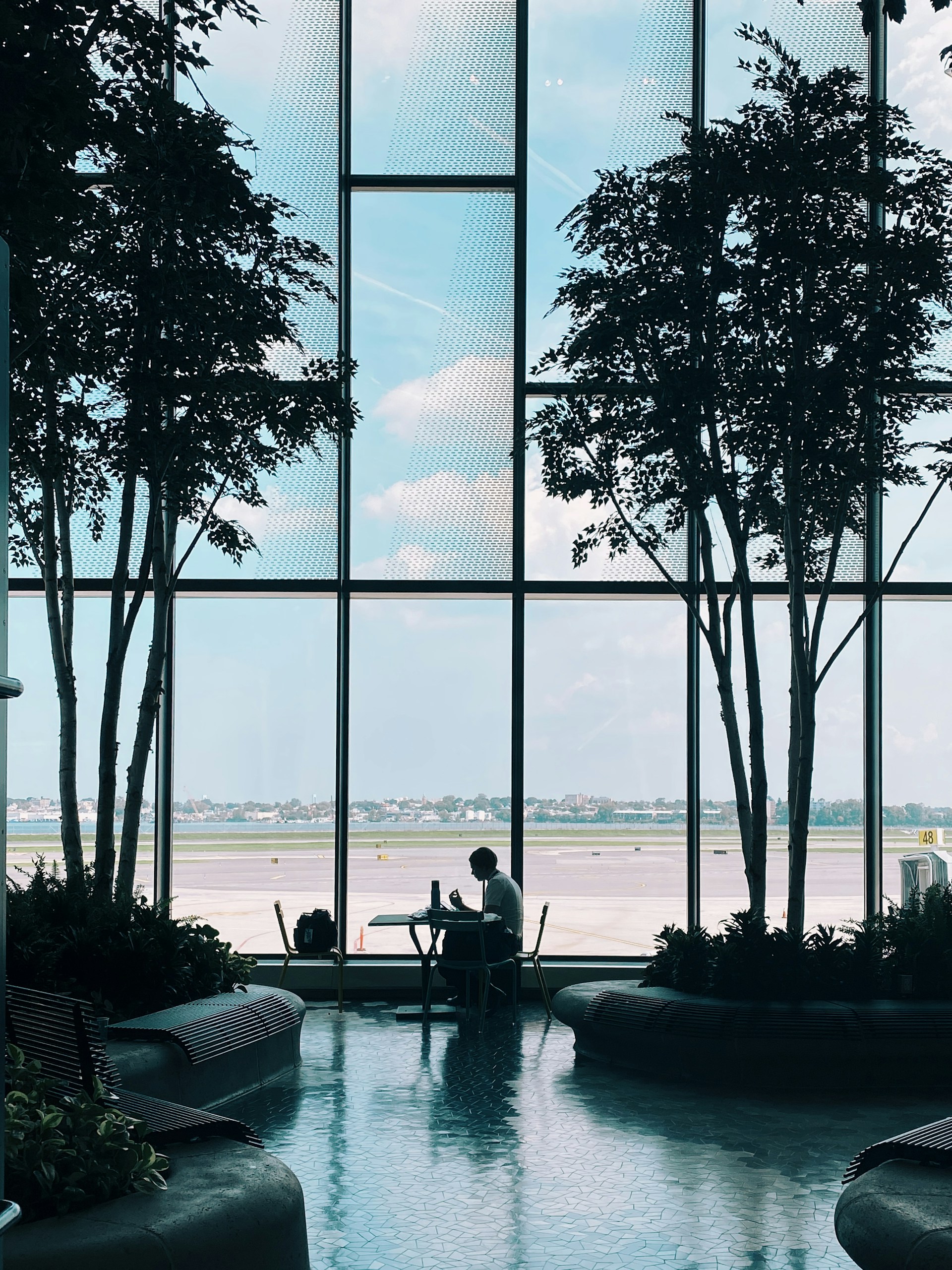 2 person sitting on chair near body of water during daytime
