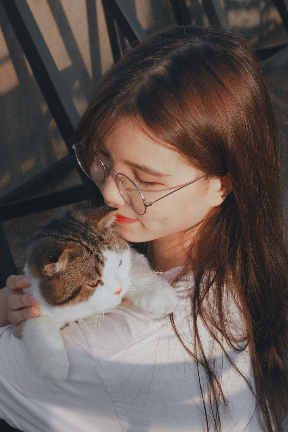 a woman holding a cat in her arms