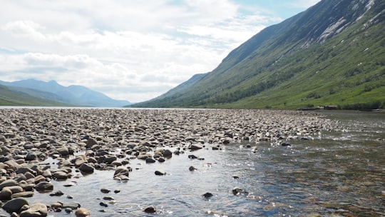 gray rocks on river during daytime in Loch Etive United Kingdom