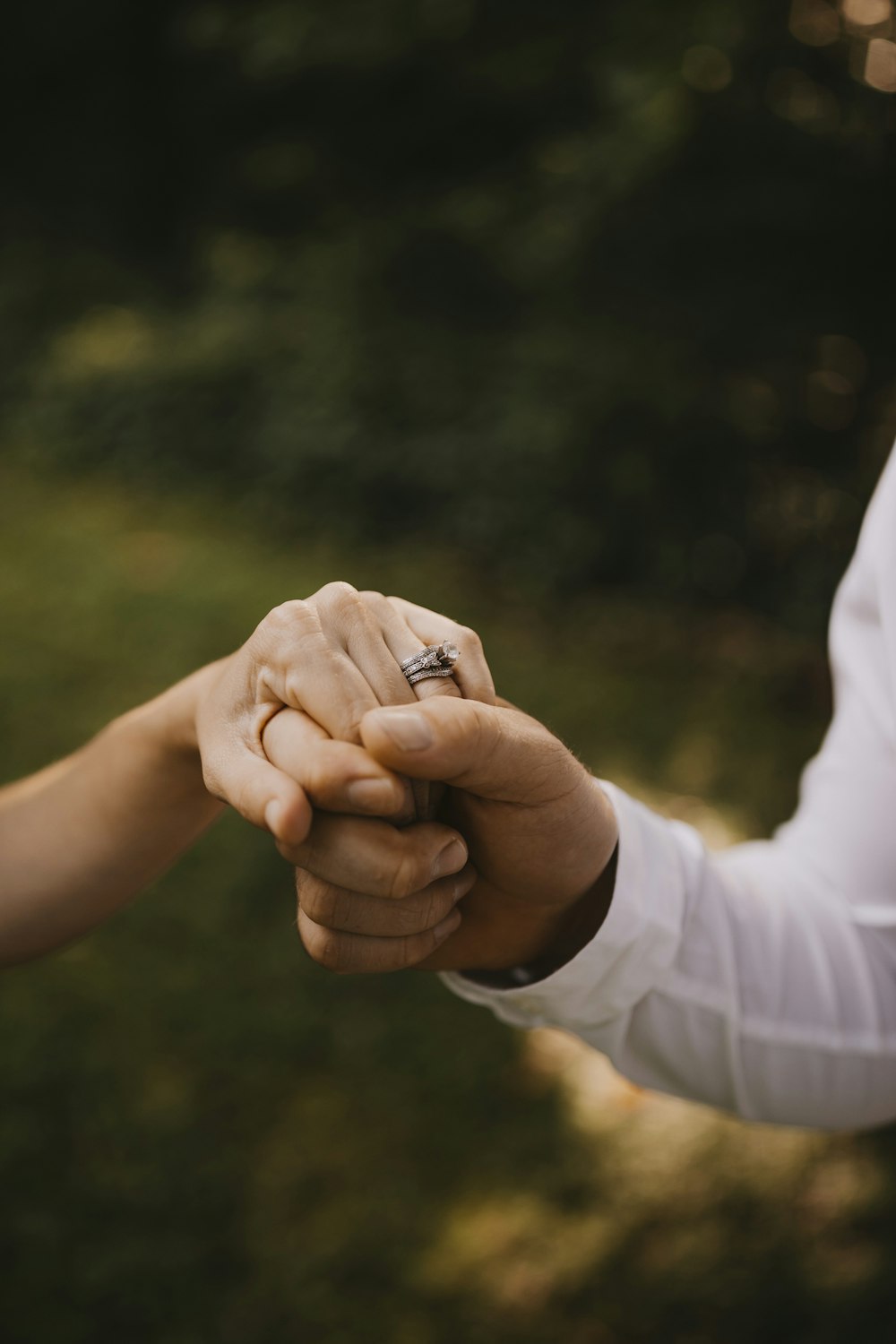 person holding a silver ring