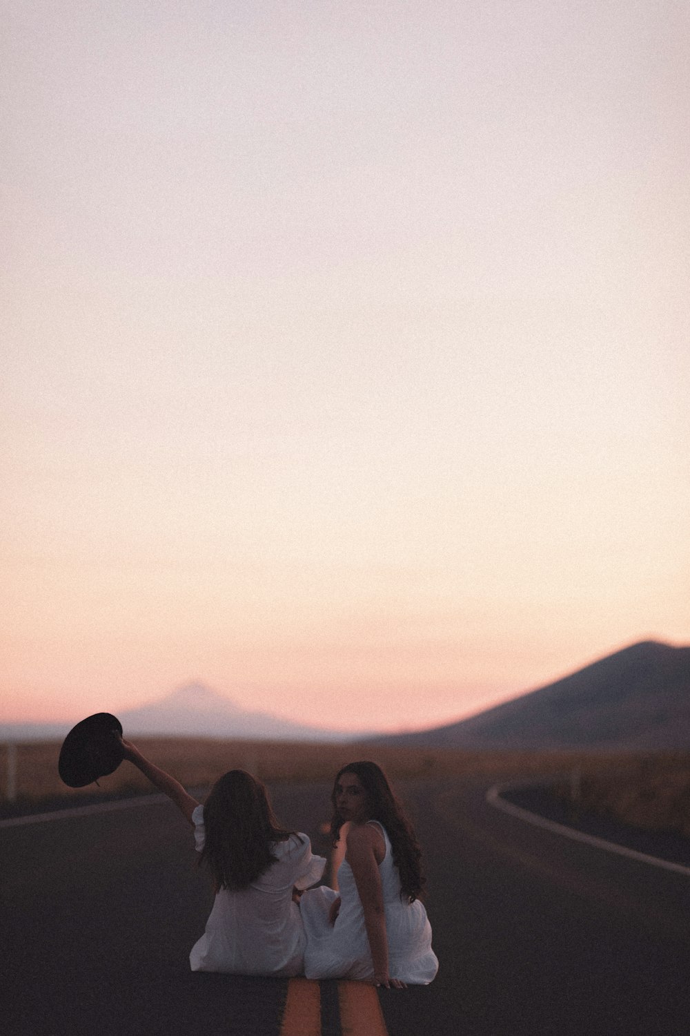 silhouette of people on top of mountain during sunset