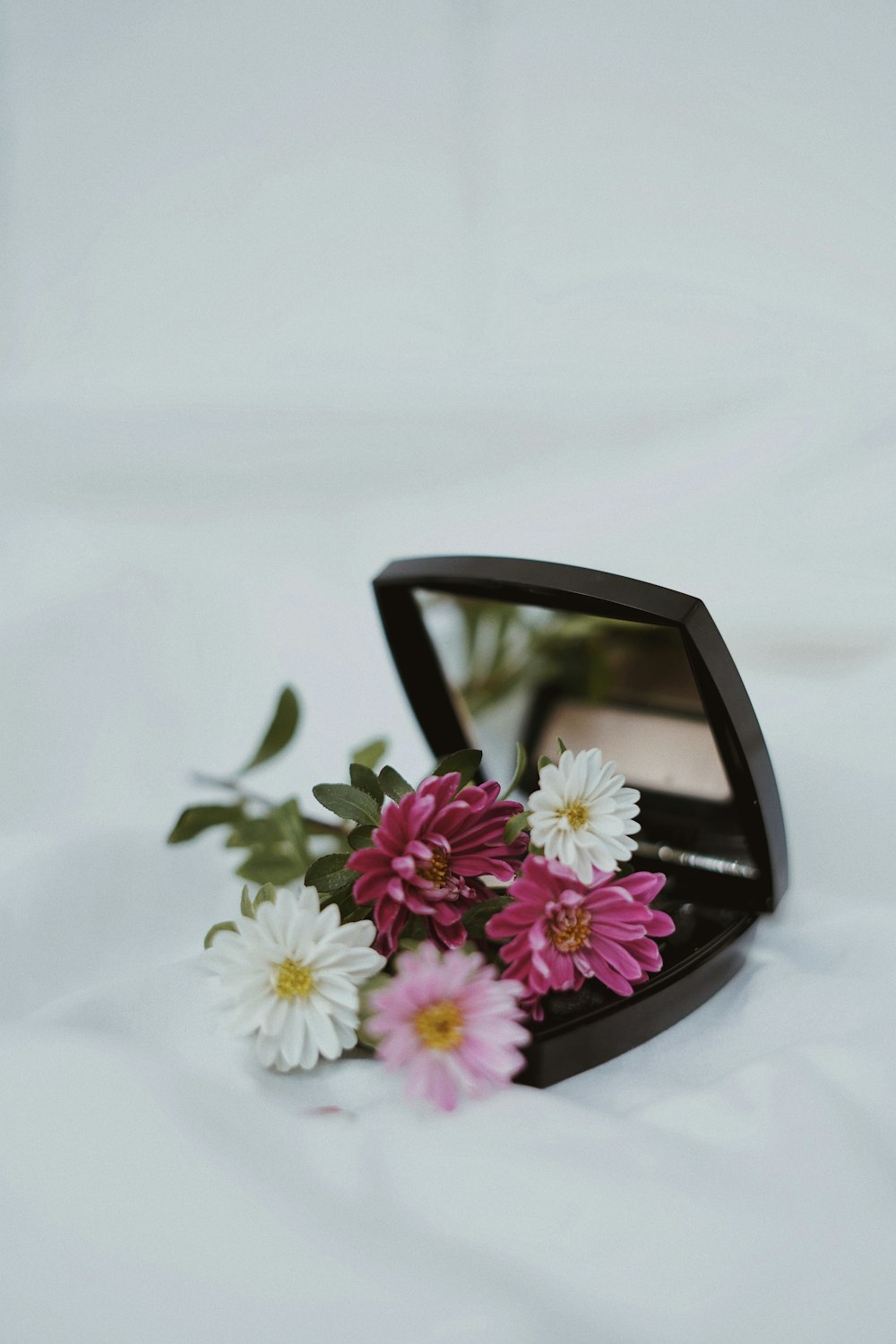 white and pink flower on black frame sunglasses