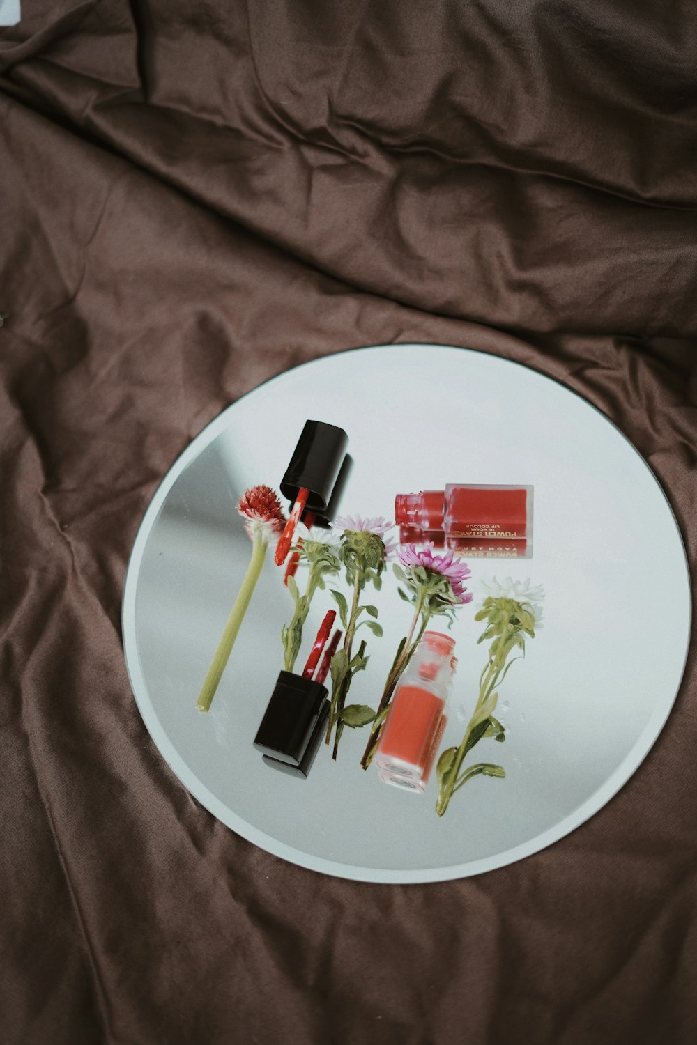 white and pink labeled soft tubes on white round plate