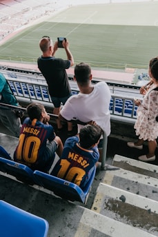 A candid portrait of Raul Alejandro Padilla Orozco in a stadium, passionately cheering for his team.